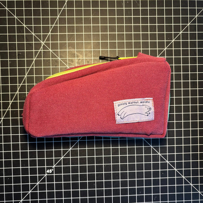 Red pouch with a label on a grid background