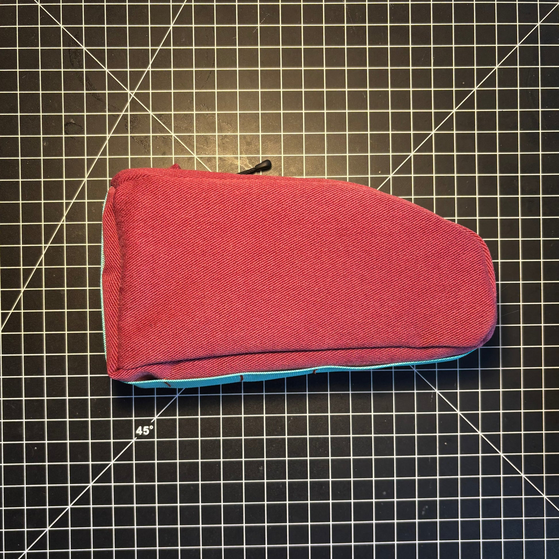 Red fabric pouch on a grid background